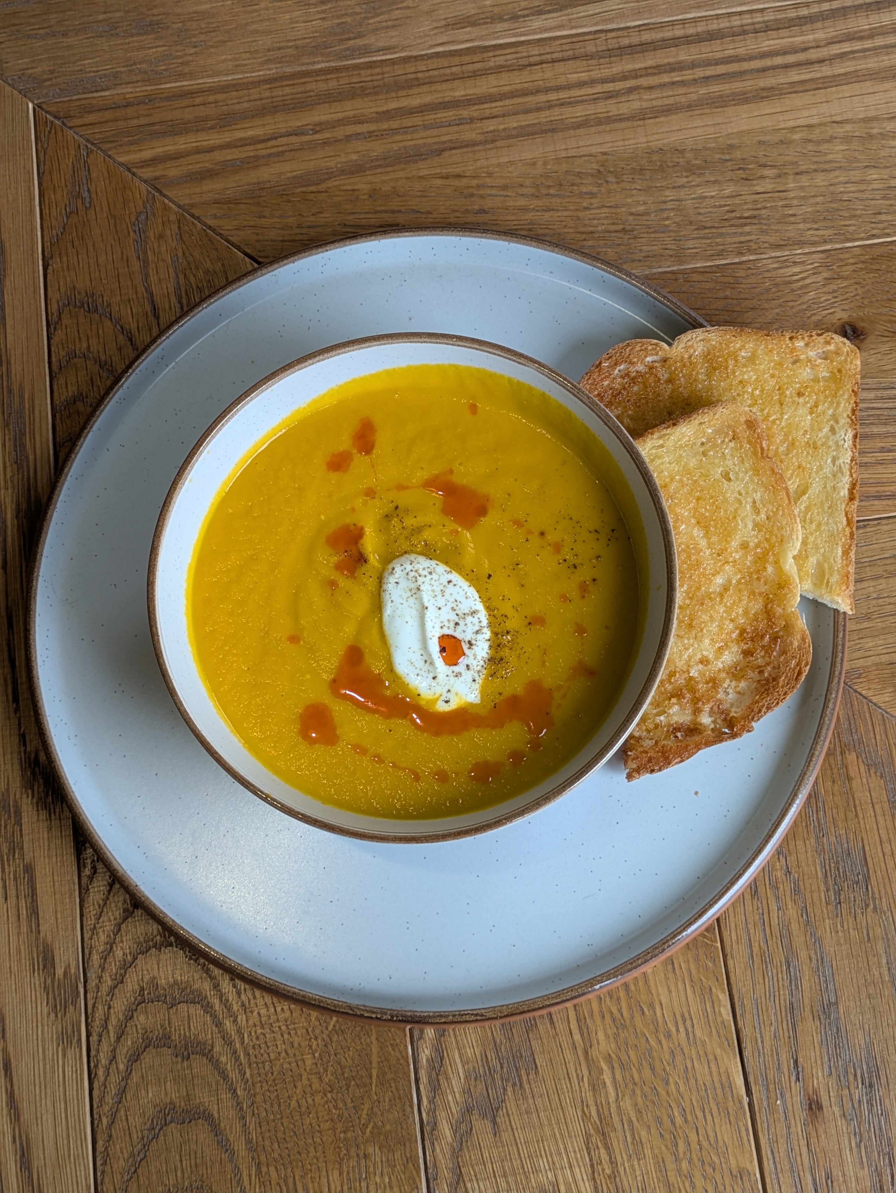 A rich carrot soup infused with Jan’s Golden Kraut seasoning, topped with creme fraiche and chili oil – perfect for a comforting lunch.