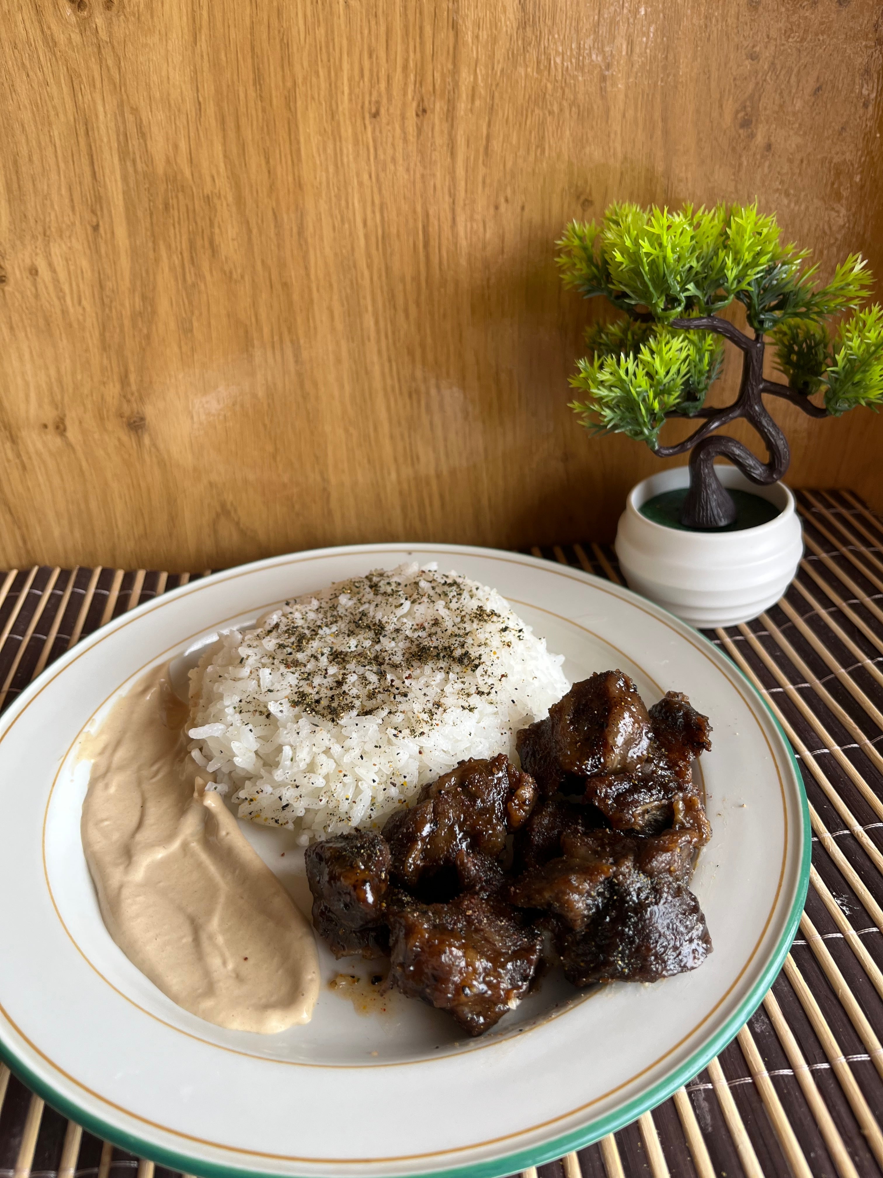 Hot honey beef cubes served with fluffy rice topped with umami seasoning and garlic mayo on the side